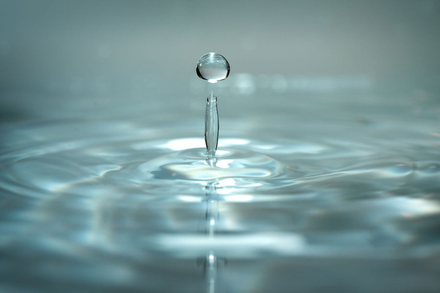 A single drop of water falling into still water